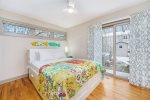 This queen bedroom has direct access to the backyard, hot tub, and guest bathroom